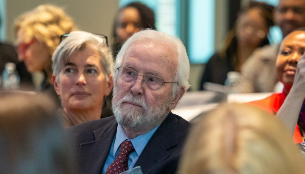FINCA Board Member Catherine Mohr and Founding Member John Hatch listen to the pitches. Hatch has long espoused the importance of impact investing in Africa.