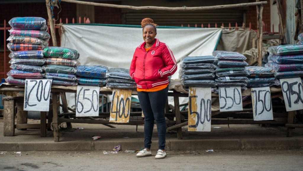 Margaret Mbuthia stands in front of her shop stall. Success of women like Margaret is highlight from 2023.