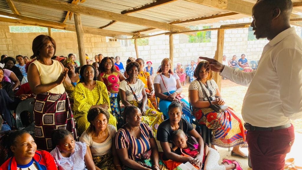 A participant in the training asks a question of one of the instructors from FINCA Zambia.