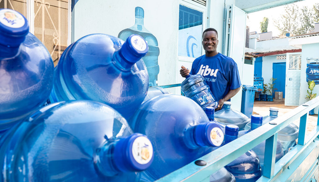Alex Bwire of Jibu loads his delivery vehicle with with clean, fresh water for his customers.