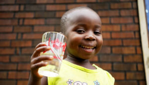 Child Holding a Glass of Clean Water
