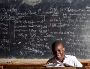 A student in front of a blackboard shows the value of early childhood education