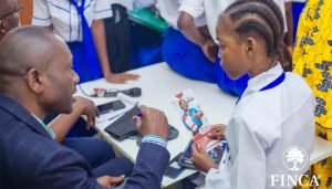 FINCA staff building resilience in the DRC through a school financial literacy program.