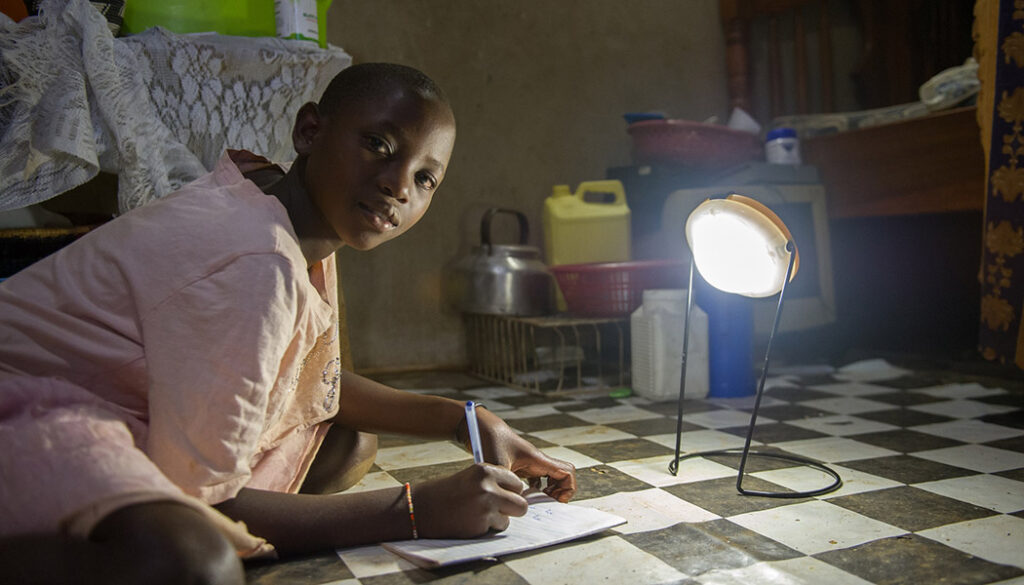 Child studying by solar light through FINCA's BrightLife Program