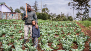 NatureLock farmer David Chege on his farm with his son