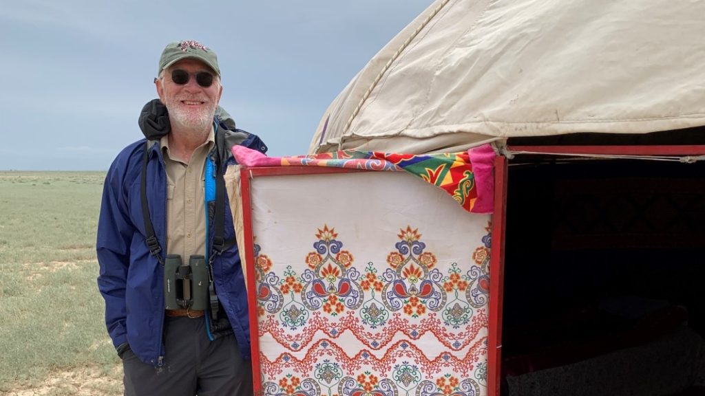 FINCA donor Ferenc M. standing beside the yurt that he and his wife stayed in while in Kazakhstan’s Tau Kum Desert.