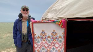 FINCA donor Ferenc M. standing beside the yurt that he and his wife stayed in while in Kazakhstan’s Tau Kum Desert.