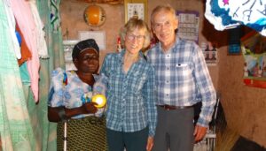 Mwangaza project client Joyce Ajidiru holdin her Pico lamp with Karen and Ken Gerdes.