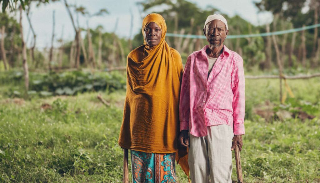 A farming family standing in their field