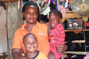 BrightLife sales agent Violet Namirembe with her children.