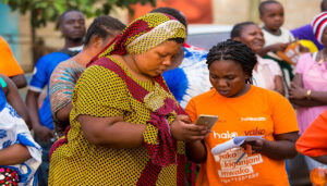 A FINCA client receives training on mobile banking.