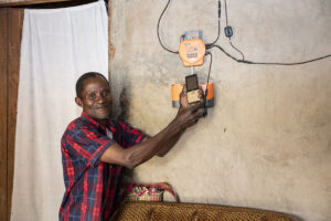 BrightLife client Godfrey Ssegawa with his solar home system
